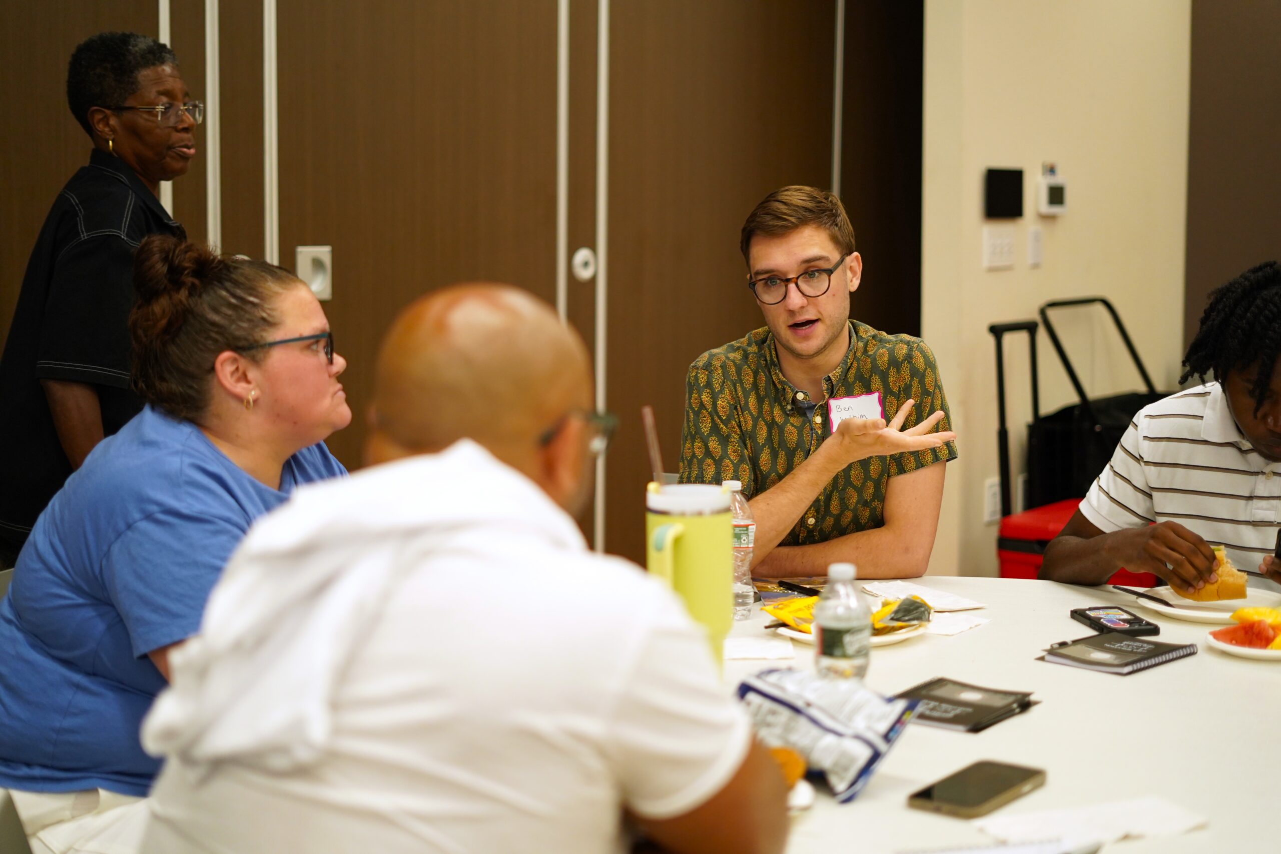 Participants in conversation around a table at a MAHRWC training