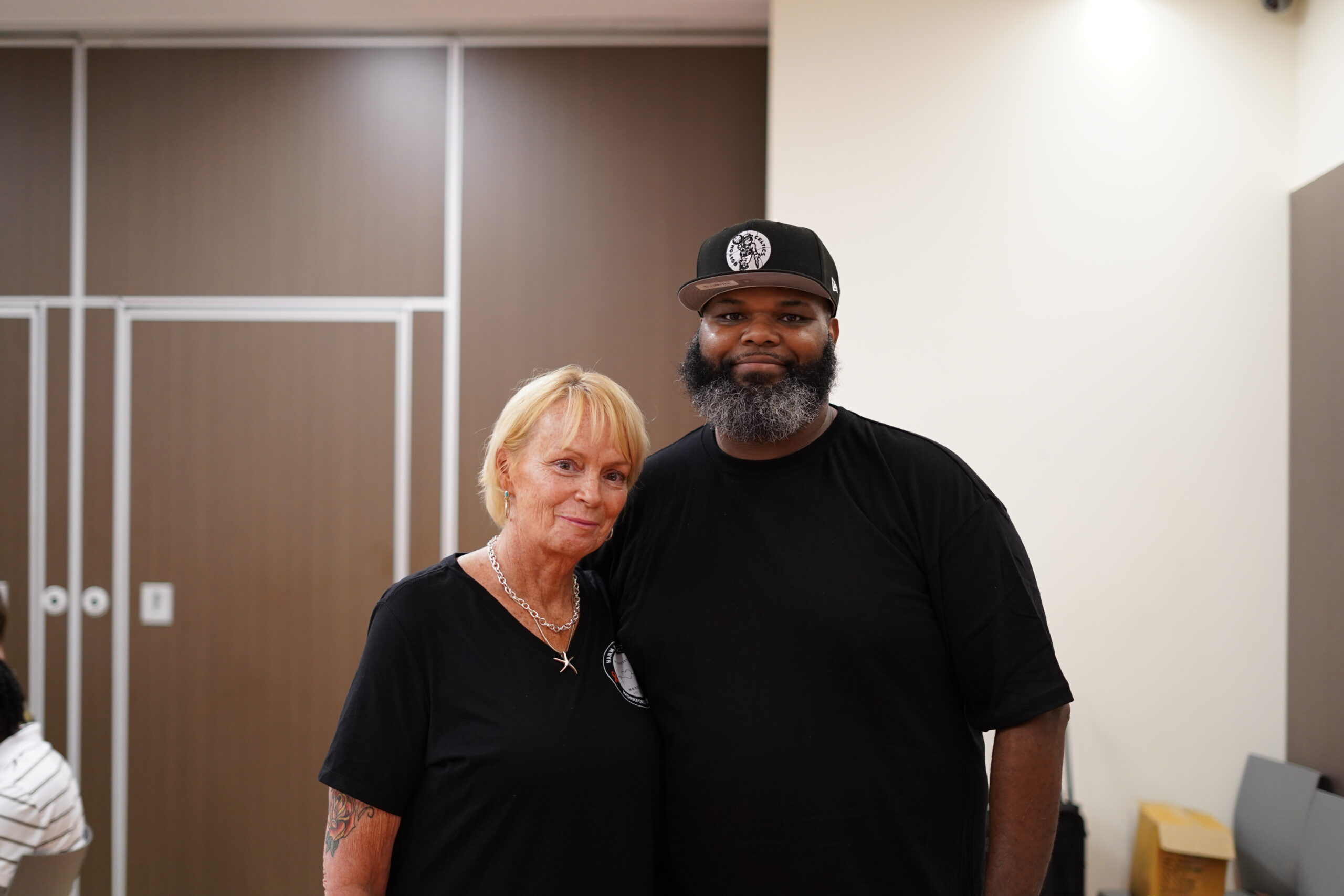 Two harm reduction workers smiling and posing together at a MAHRWC training